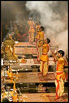 Young priests open Puja ceremony by blowing a conch-shell. Varanasi, Uttar Pradesh, India (color)