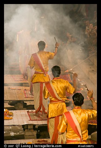 Brahmans standing amongst clouds of incense during puja. Varanasi, Uttar Pradesh, India