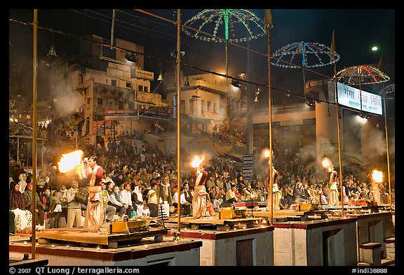 Pujari (priests) performing arti ceremony in front of large attendance. Varanasi, Uttar Pradesh, India (color)