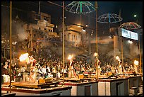 Pujari (priests) performing arti ceremony in front of large attendance. Varanasi, Uttar Pradesh, India