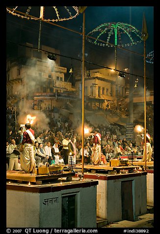 Holy hindu men facing audience during evening arti ceremony. Varanasi, Uttar Pradesh, India (color)