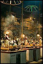 Holy hindu men facing audience during evening arti ceremony. Varanasi, Uttar Pradesh, India (color)