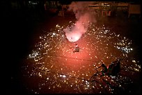 Man firing fireworks in middle of street ahead of wedding procession. Varanasi, Uttar Pradesh, India (color)