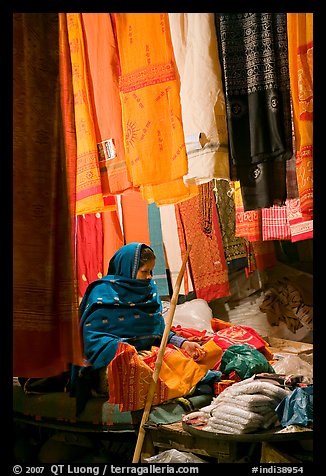 Woman selling fabrics at night. Varanasi, Uttar Pradesh, India (color)