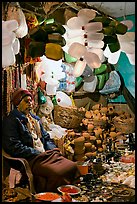 Man selling water jugs and other supplies for pilgrims near the Ganges River. Varanasi, Uttar Pradesh, India (color)