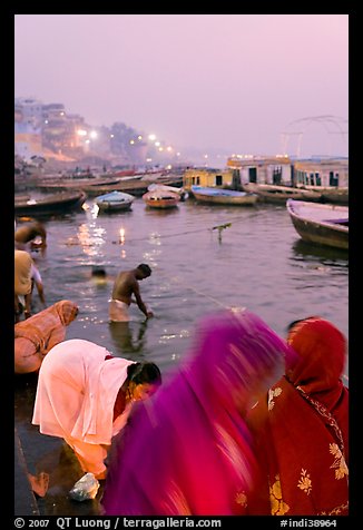 Women on the banks of the Ganga River in rosy dawn light. Varanasi, Uttar Pradesh, India (color)