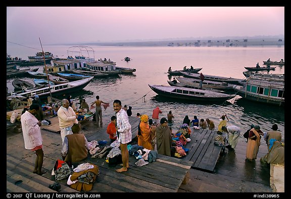 Men preparing for ritual bath on banks of Ganges River at dawn. Varanasi, Uttar Pradesh, India (color)