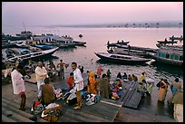 Men preparing for ritual bath on banks of Ganges River at dawn. Varanasi, Uttar Pradesh, India ( color)