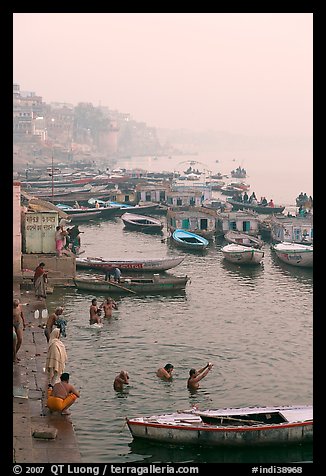 Pilgrims taking a holy dip in the Ganga River at dawn. Varanasi, Uttar Pradesh, India