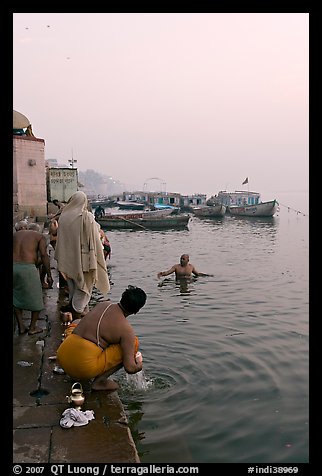 Hindu men dipping in the Ganges River at dawn. Varanasi, Uttar Pradesh, India