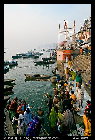 Boat unloading pilgrim onto Dasaswamedh Ghat, early morning. Varanasi, Uttar Pradesh, India (color)