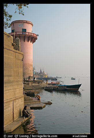 Man sitting on edge of Ganges River. Varanasi, Uttar Pradesh, India