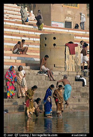 Women dipping feet in Ganga water at Sankatha Ghat. Varanasi, Uttar Pradesh, India