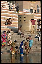 Women dipping feet in Ganga water at Sankatha Ghat. Varanasi, Uttar Pradesh, India