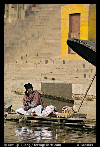 Man sitting near unbrella. Varanasi, Uttar Pradesh, India