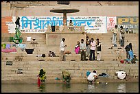 People washing cloths, steps, and Indi inscriptions. Varanasi, Uttar Pradesh, India ( color)