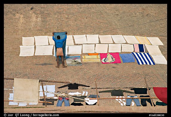 Man laying out laundry for drying. Varanasi, Uttar Pradesh, India (color)