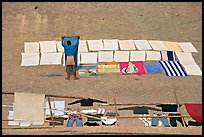 Man laying out laundry for drying. Varanasi, Uttar Pradesh, India ( color)