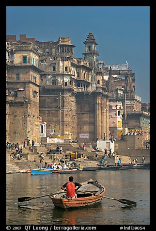 Man rowing boat beneath Munshi Ghat. Varanasi, Uttar Pradesh, India (color)