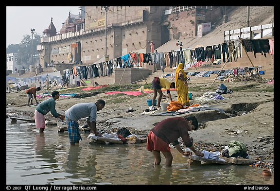 Men washing laundry on Ganga riverbanks. Varanasi, Uttar Pradesh, India