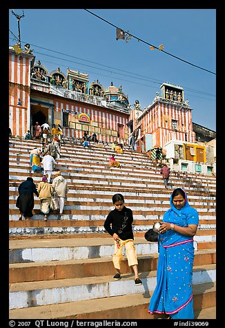 Woman and boy on temple steps, Kedar Ghat. Varanasi, Uttar Pradesh, India