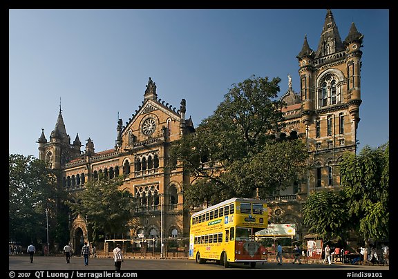 Yellow double-decker bus in front of Victoria Terminus. Mumbai, Maharashtra, India