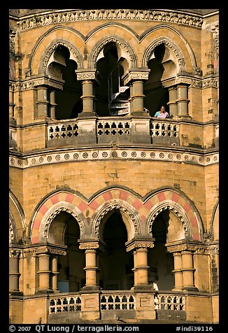 Facade with woman at window, Chhatrapati Shivaji Terminus. Mumbai, Maharashtra, India