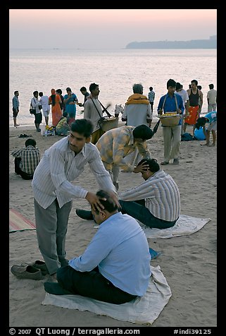 Head rub given by malish-wallah, Chowpatty Beach. Mumbai, Maharashtra, India (color)