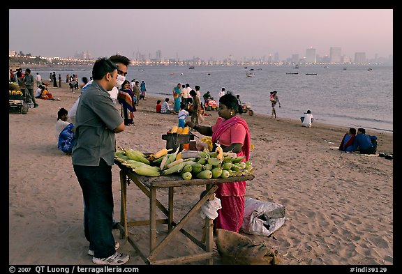 Food stall selling braised corn at twilight,  Chowpatty Beach. Mumbai, Maharashtra, India