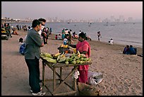 Food stall selling braised corn at twilight,  Chowpatty Beach. Mumbai, Maharashtra, India (color)