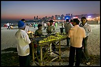 Stall broiling corn at night, Chowpatty Beach. Mumbai, Maharashtra, India (color)