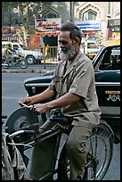 Man sharpening knifes on the street, Colaba. Mumbai, Maharashtra, India