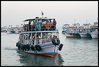 Tour boat loaded with passengers. Mumbai, Maharashtra, India (color)