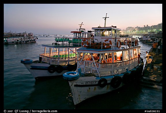 Lighted tour boat at quay,  sunset. Mumbai, Maharashtra, India (color)