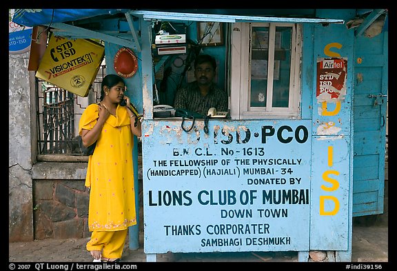 Woman at a street telephone booth. Mumbai, Maharashtra, India