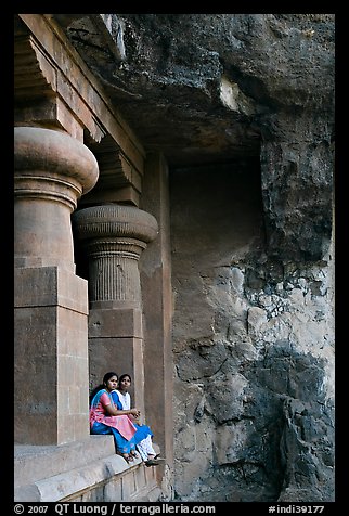 Women sitting at entrance of cave, Elephanta Island. Mumbai, Maharashtra, India