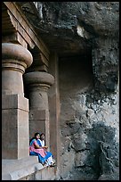 Women sitting at entrance of cave, Elephanta Island. Mumbai, Maharashtra, India