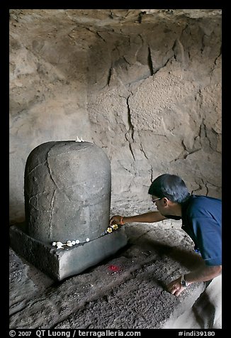 Man venerating a Linga in Shiva shrine, Elephanta Island. Mumbai, Maharashtra, India (color)