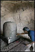 Man venerating a Linga in Shiva shrine, Elephanta Island. Mumbai, Maharashtra, India ( color)