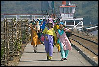 Women walking on  jetty, Elephanta Island. Mumbai, Maharashtra, India