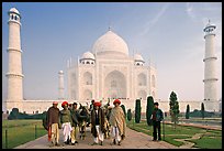 Men with turbans and cows in front of Taj Mahal, early morning. Agra, Uttar Pradesh, India