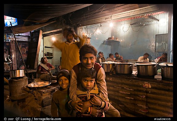 Children and food booth at night, Agra cantonment. Agra, Uttar Pradesh, India