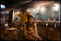 Children and food booth at night, Agra cantonment. Agra, Uttar Pradesh, India