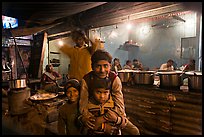 Children and food booth at night, Agra cantonment. Agra, Uttar Pradesh, India (color)