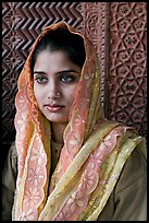 Young woman with embroided scarf, in front of Rumi Sultana wall. Fatehpur Sikri, Uttar Pradesh, India ( color)