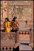 Young women sitting in the center of Ornamental pool. Fatehpur Sikri, Uttar Pradesh, India ( color)