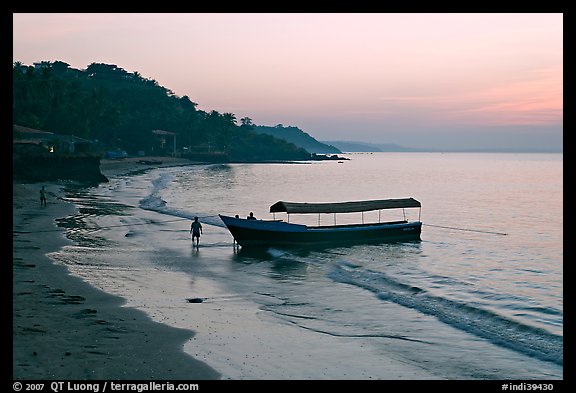 Narrow boat on beach at dawn, Dona Paula. Goa, India (color)