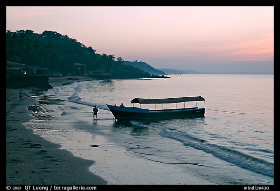 Narrow boat on beach at dawn, Dona Paula. Goa, India