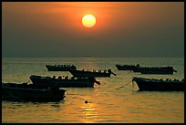 Boats anchored in bay and sunrise, Dona Paula. Goa, India