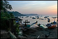 Fishing boats on beach, sunrise. Goa, India